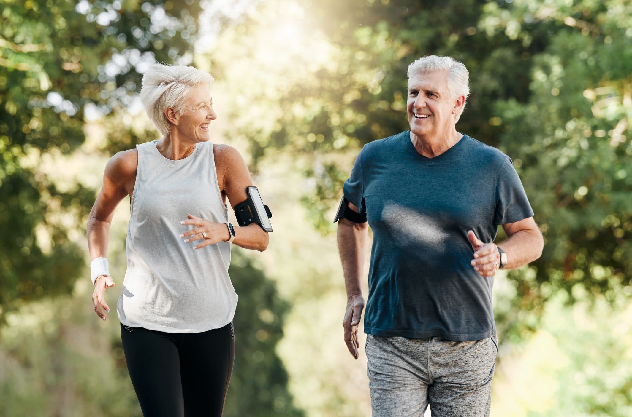 Older couple jogging in a park