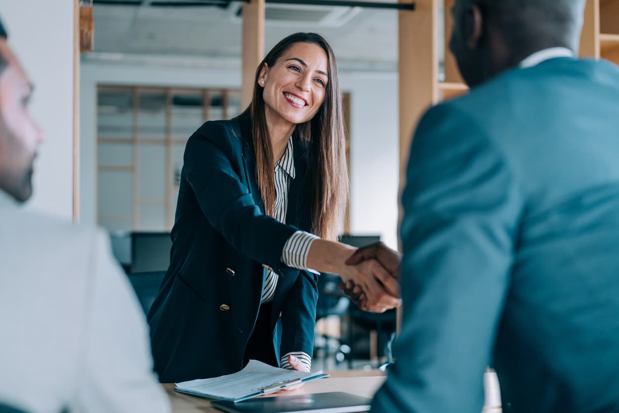 trustworthy agent shakes hands with client