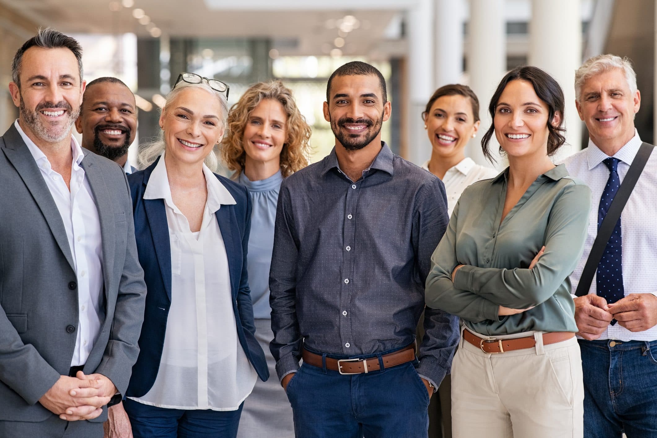 Group of smiling coworkers standing in an office