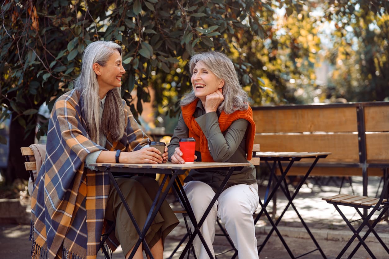 Two women talking at an outdoor café