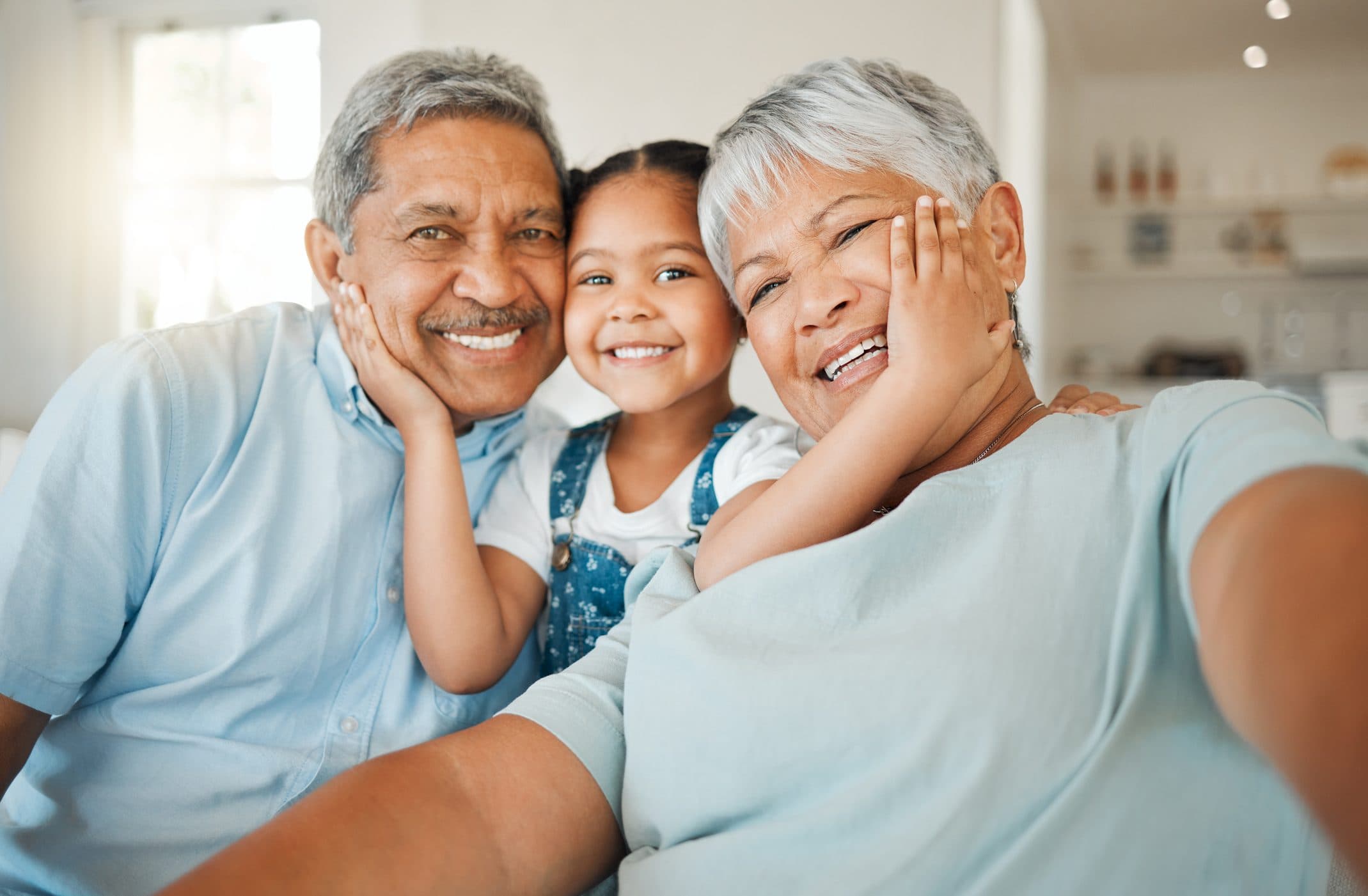 Grandparents smiling with their granddaughter