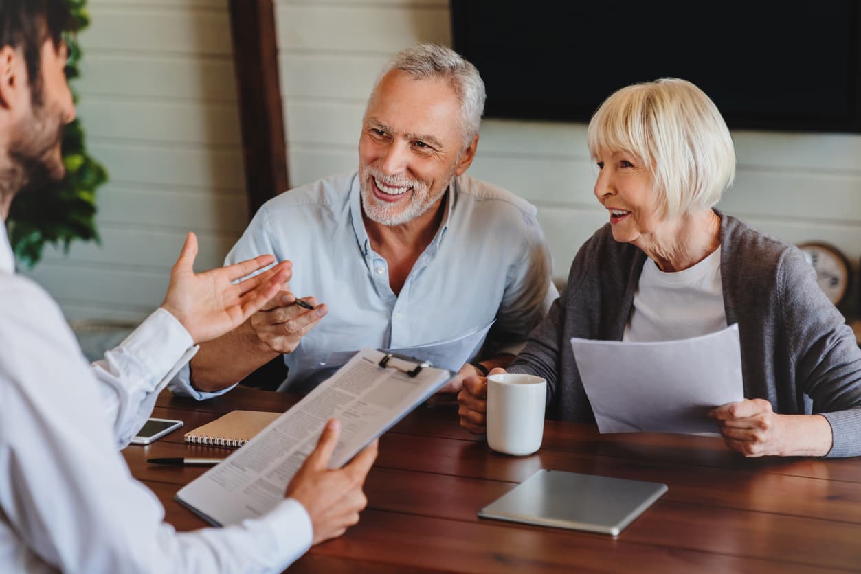 Senior couple talking to health insurance agent