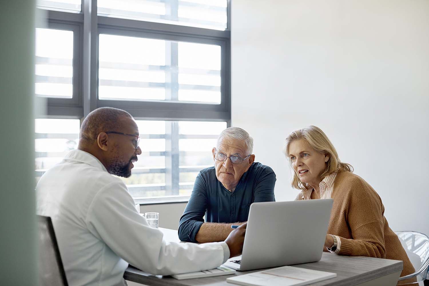 Doctor talking to senior couple